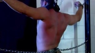 Fit guy gets bound with chains and has his back whipped